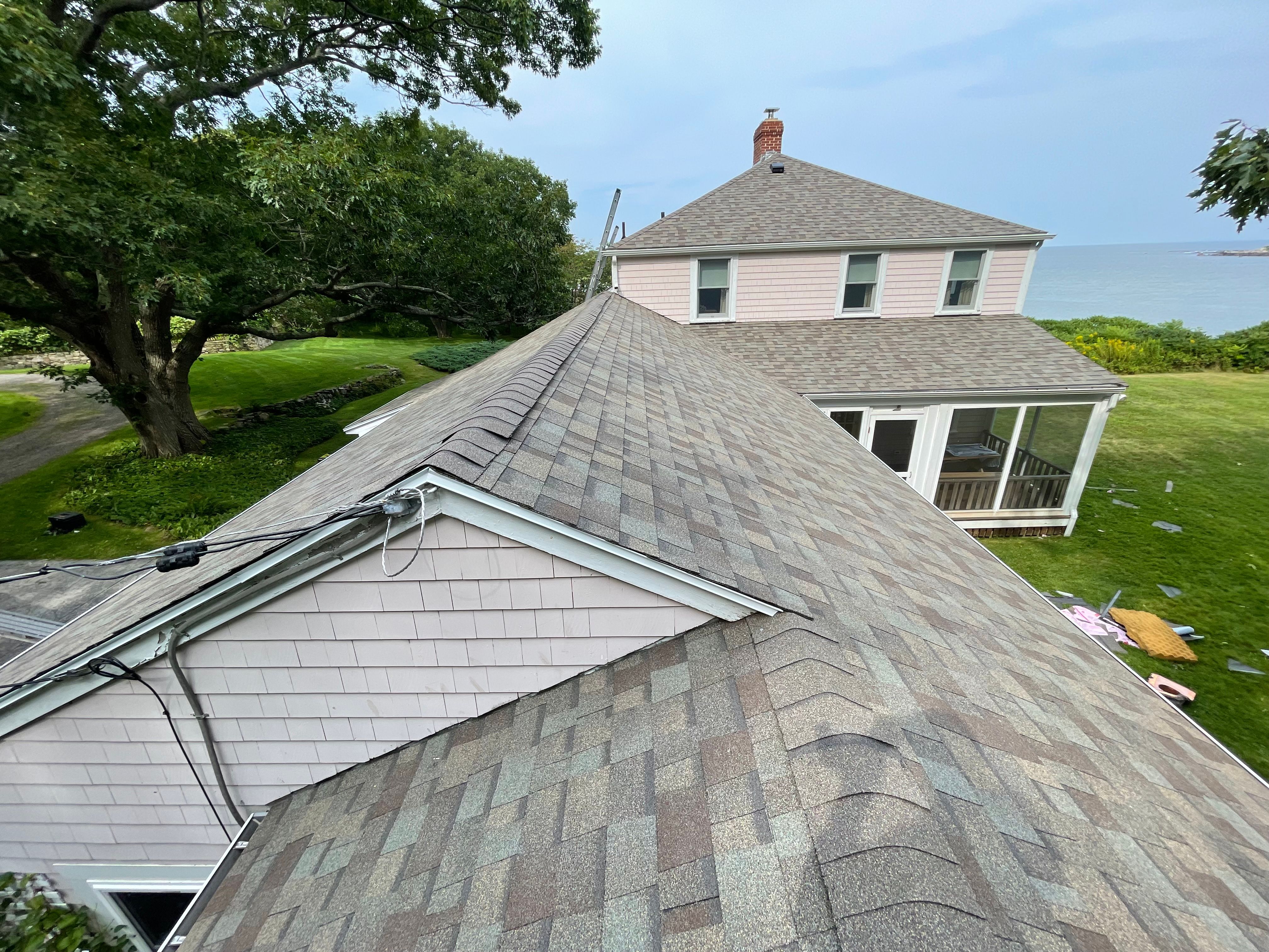 A new shingle roof on a house above the ocean, photographed from the roof during the job