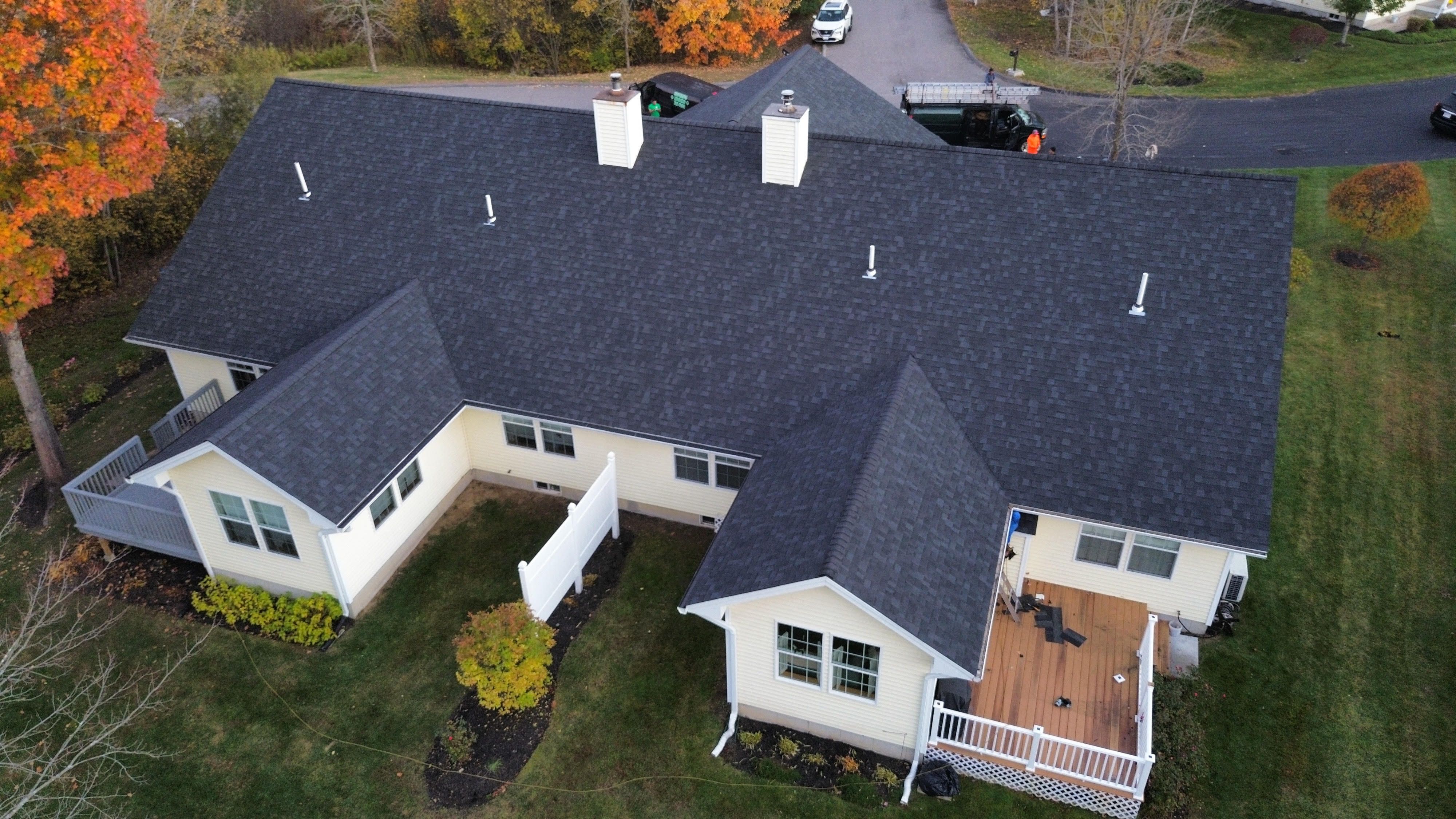 A new charcoal shingle roof on a sprawling cape in the fall